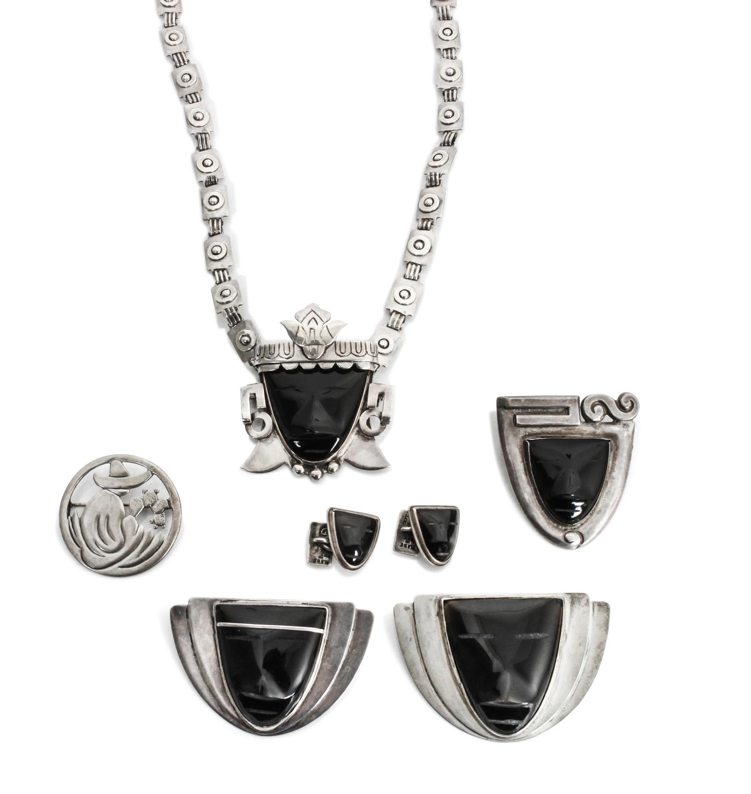 A Group of Mexican Silver and Onyx Jewelry, Frederick Davis (1880-1961) Largest brooch: 1 7/8 x 2 3/4 inches.