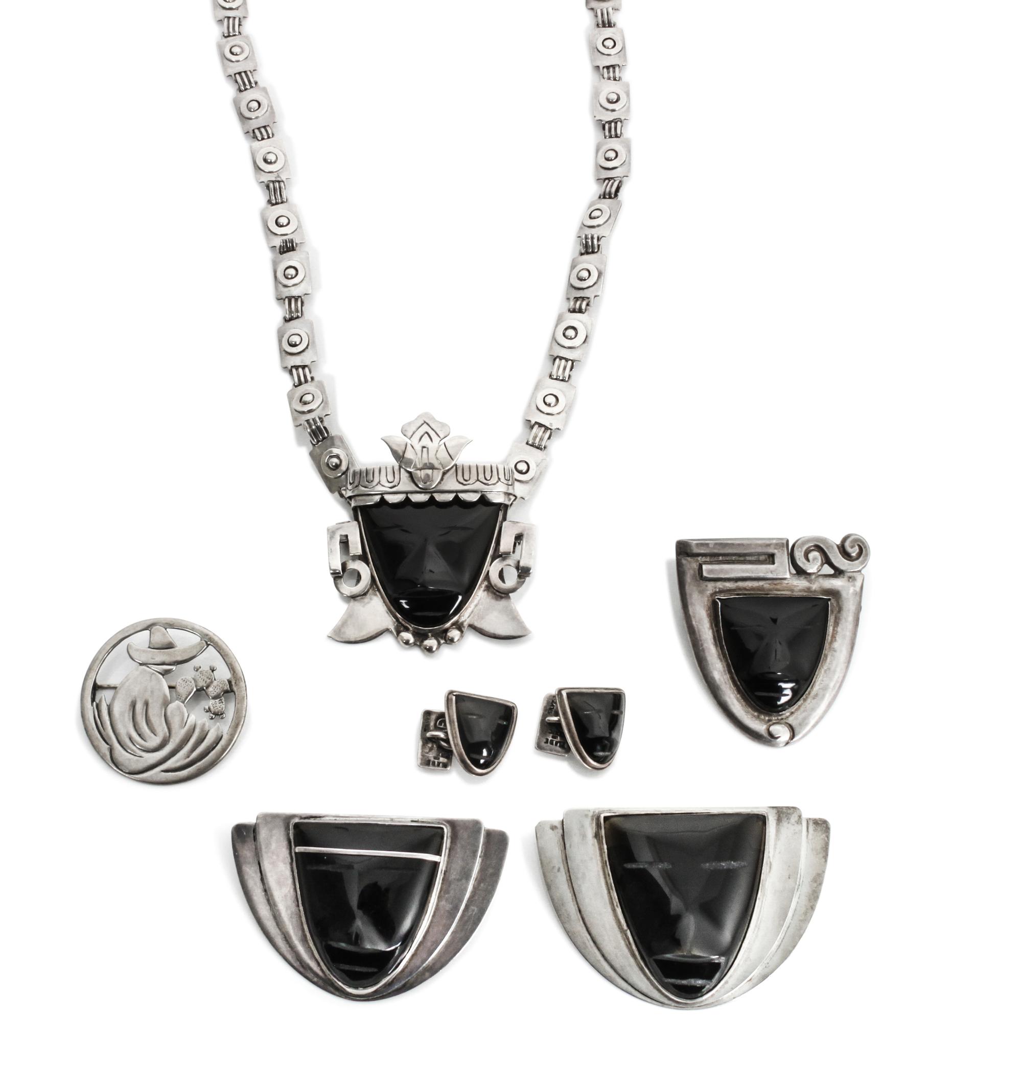 A Group of Mexican Silver and Onyx Jewelry, Frederick Davis (1880-1961) Largest brooch: 1 7/8 x 2 3/4 inches.