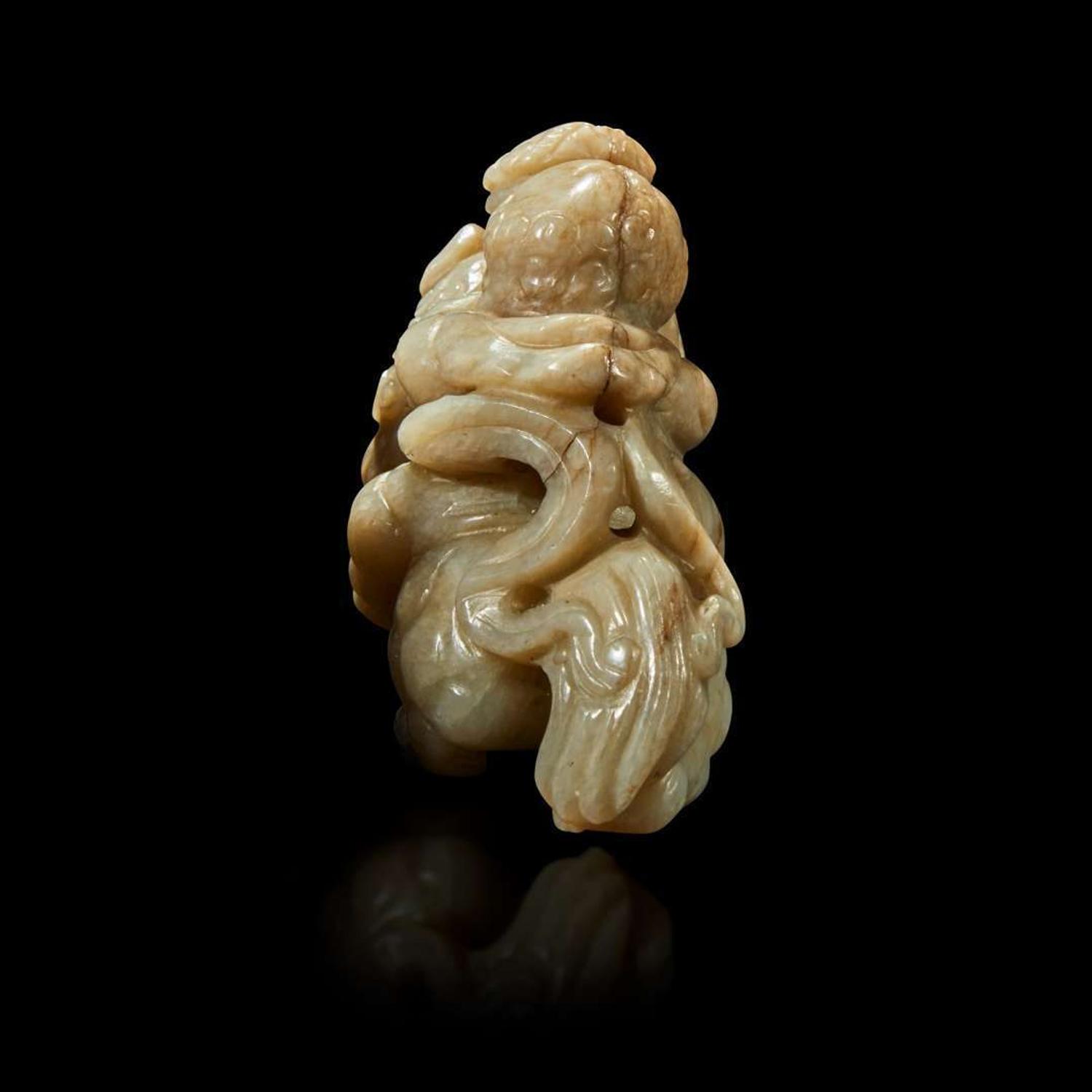 A Chinese greyish white jade carving of a foreigner on a mythical beast 18th Century or earlier