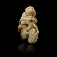 A Chinese greyish white jade carving of a foreigner on a mythical beast 18th Century or earlier