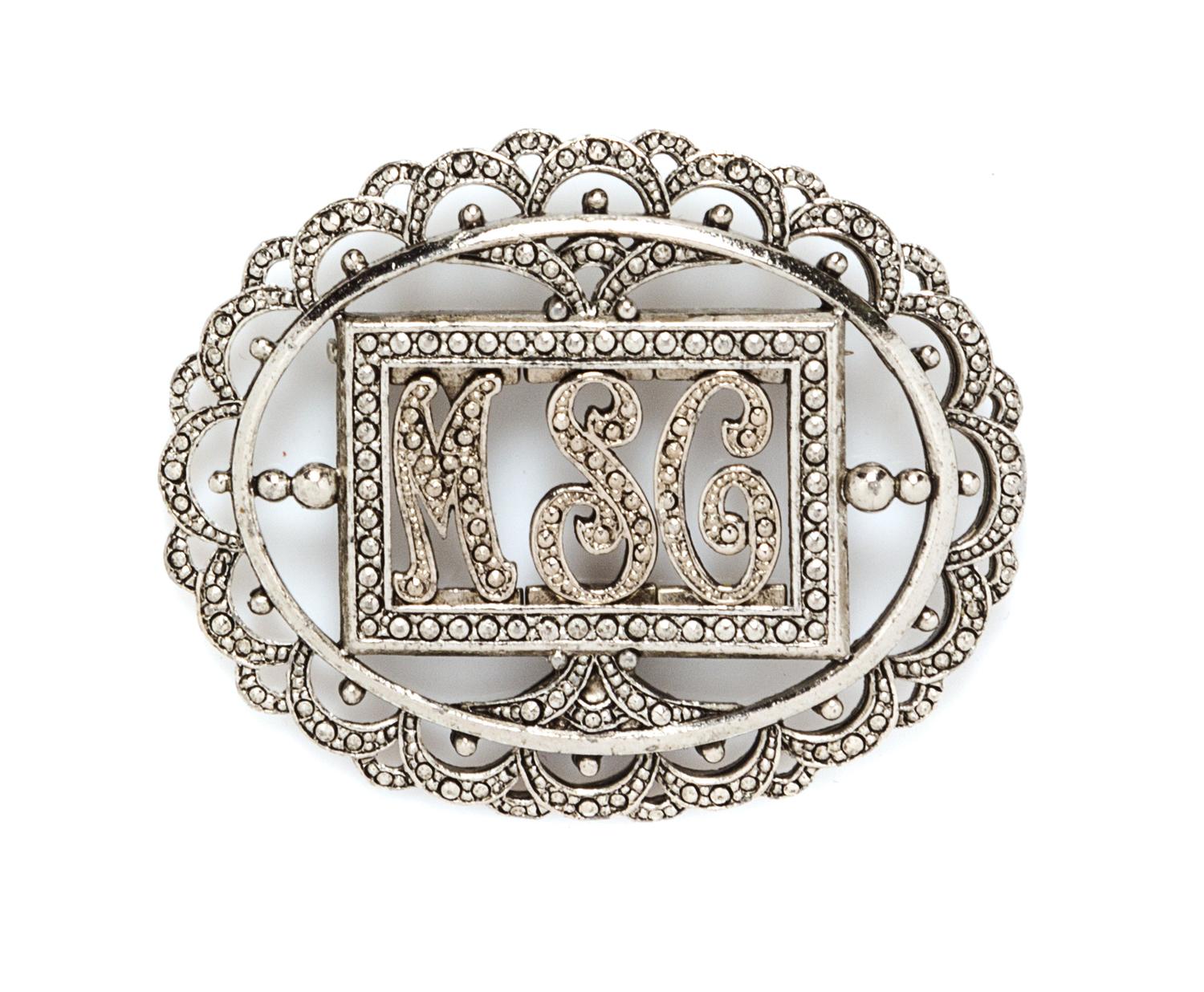A Miriam Haskell Silvertone Monogram Oval Brooch, 2.5" x 2".