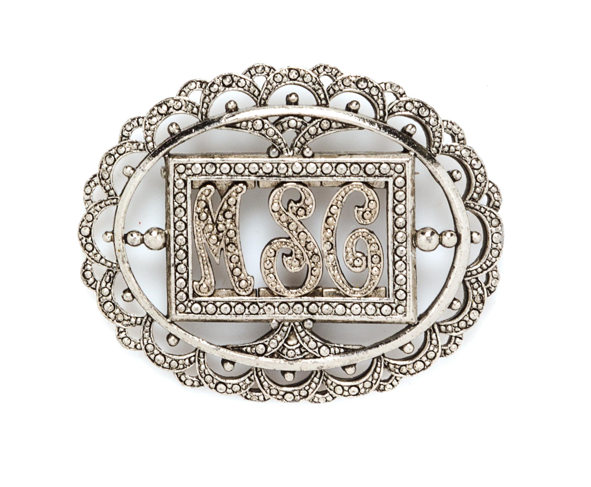 A Miriam Haskell Silvertone Monogram Oval Brooch, 2.5" x 2".