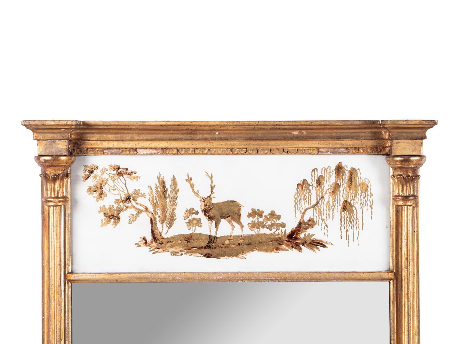 A Classical Giltwood and Eglomise Panel Inset Looking Glass