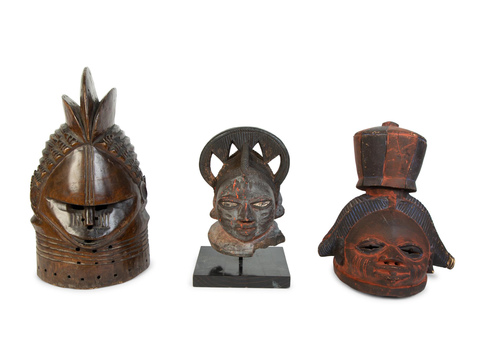 A Group of Three Helmet Masks from Tribes of West Africa — 20TH CENTURY