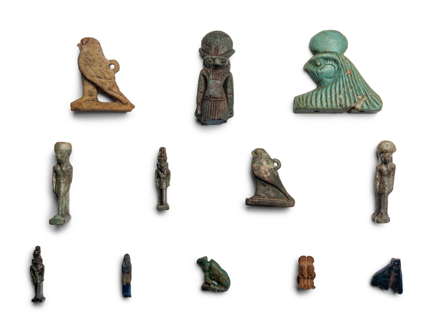 Twelve Egyptian Faience and Stone Horus Amulets