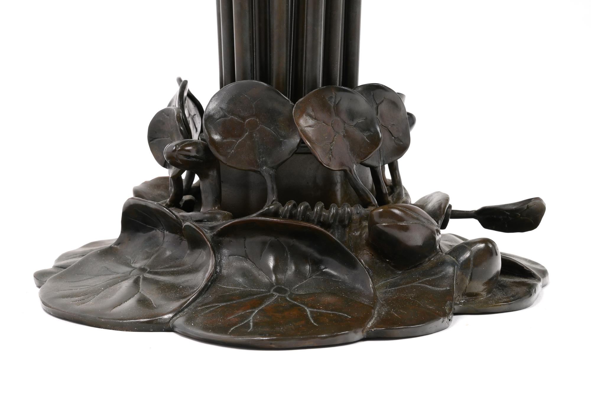 A Pair of Art Nouveau Style Patinated Metal and Iridescent Glass Eighteen-Light Tulip Lamps