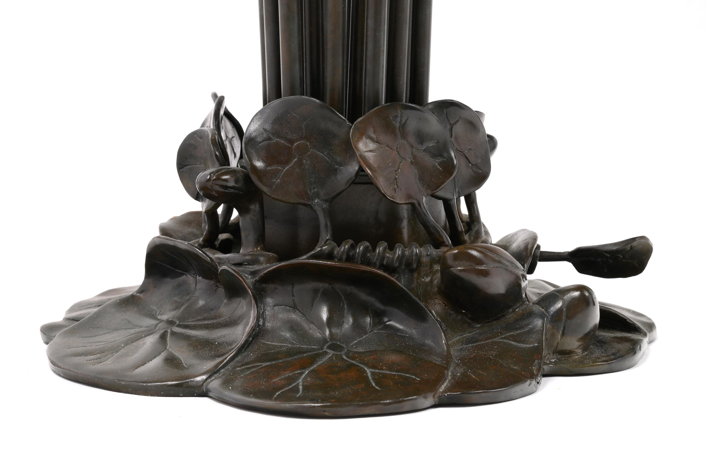 A Pair of Art Nouveau Style Patinated Metal and Iridescent Glass Eighteen-Light Tulip Lamps