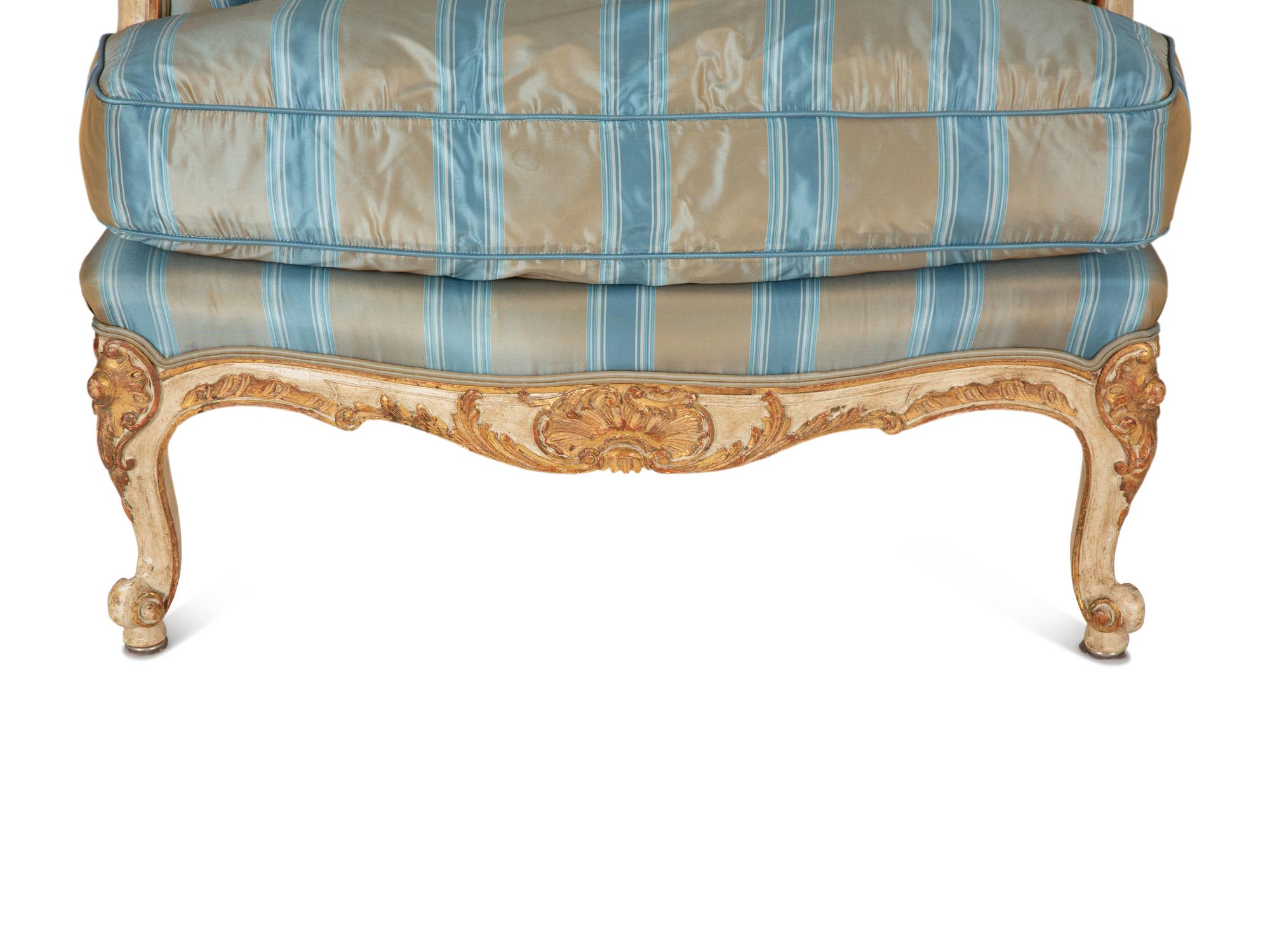 A Pair of Louis XV Style Painted and Parcel Gilt Bergeres