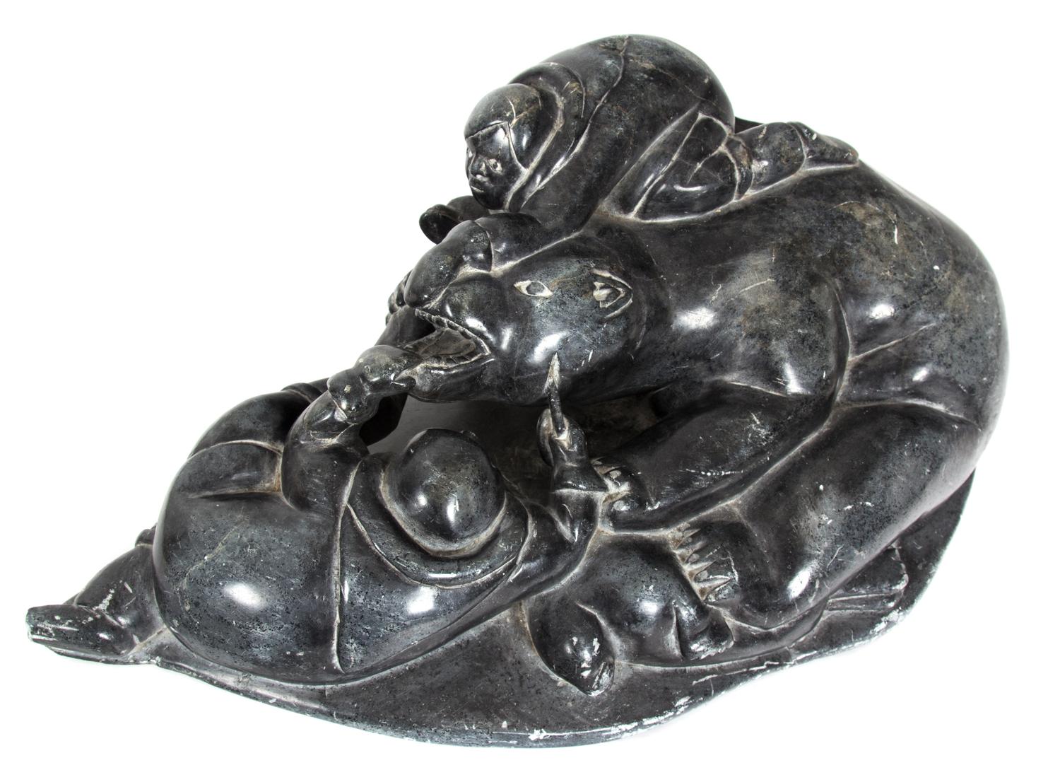 An Inuit Carved Soapstone Figure Height 7 1/4 x width 21 1/4 x depth 12 inches.