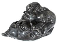 An Inuit Carved Soapstone Figure Height 7 1/4 x width 21 1/4 x depth 12 inches.