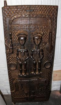 A Dogon Carved Wood Granary Door Height 56 3/4 x width 22 1/2 inches.