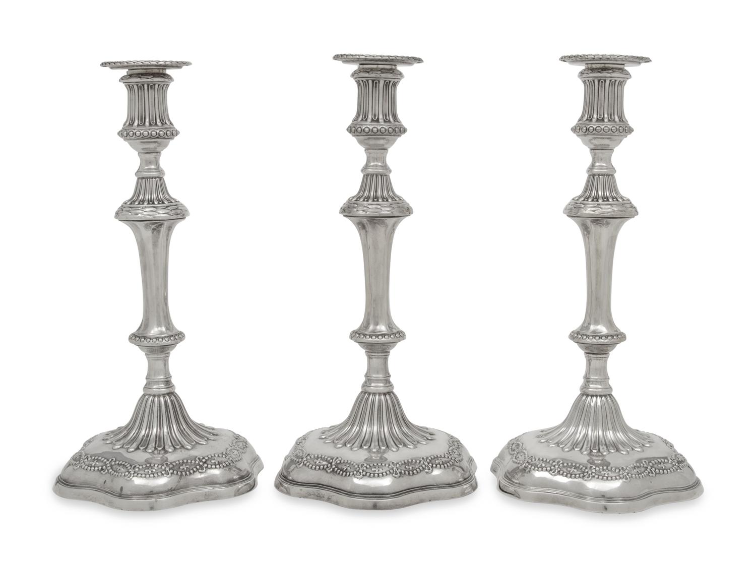 A Set of Three George III Silver Candlesticks