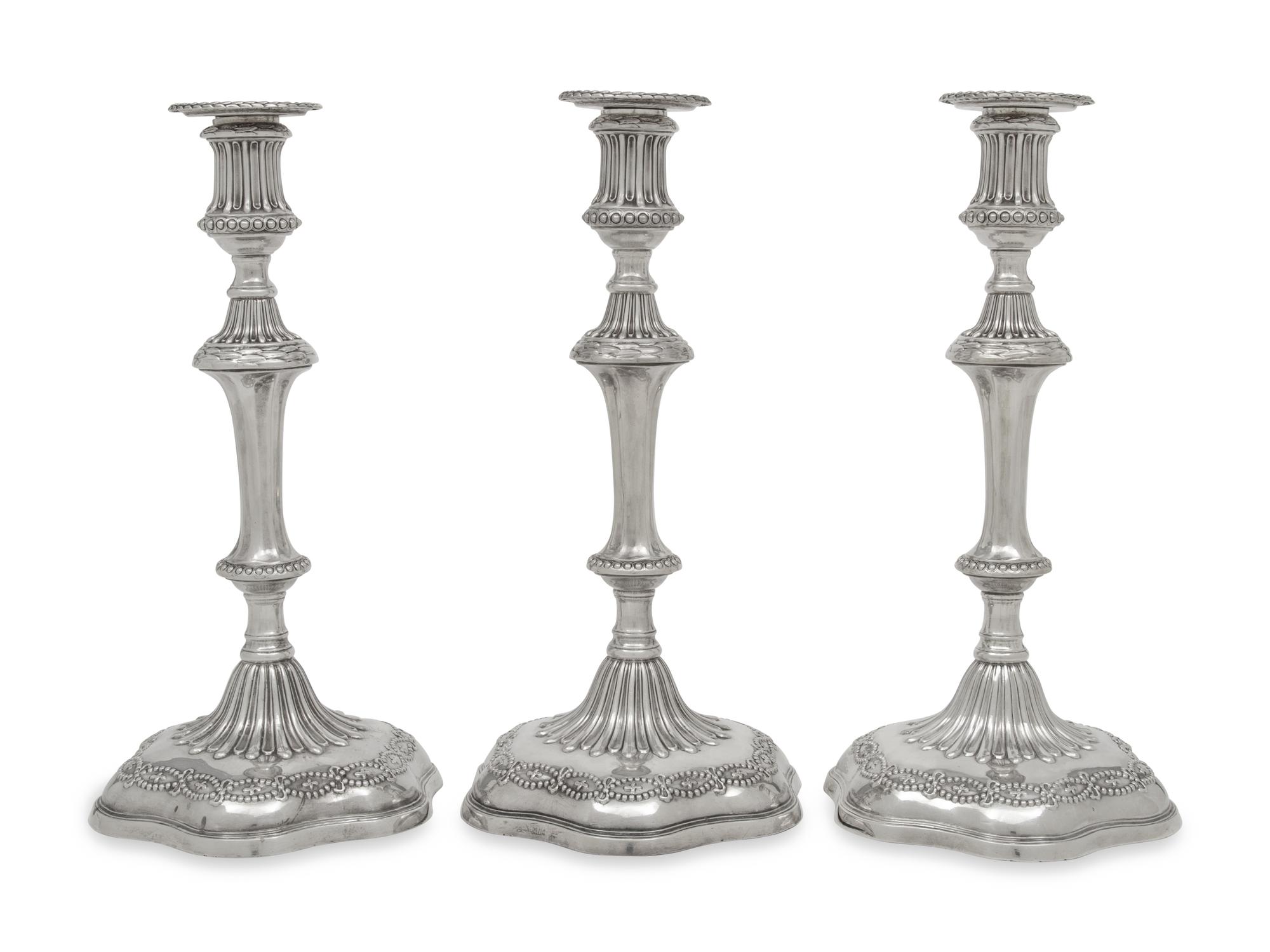 A Set of Three George III Silver Candlesticks