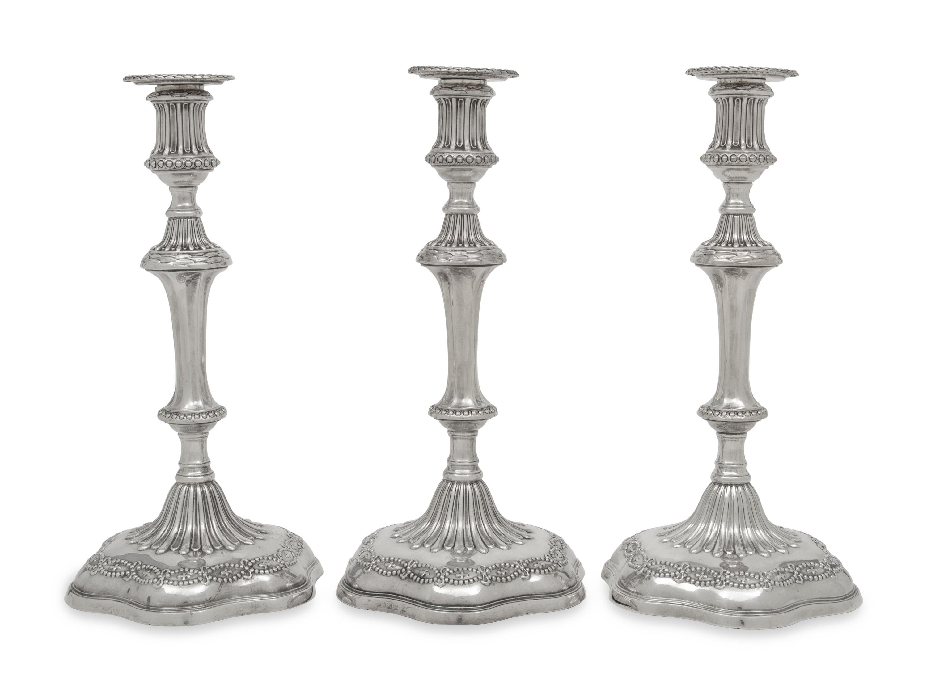 A Set of Three George III Silver Candlesticks