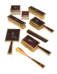 An English 9 Karat Gold Mounted Nine-Piece Dresser Set, Asprey Co., Ltd., London, Early 20th Century, having engine-turned edges, shell