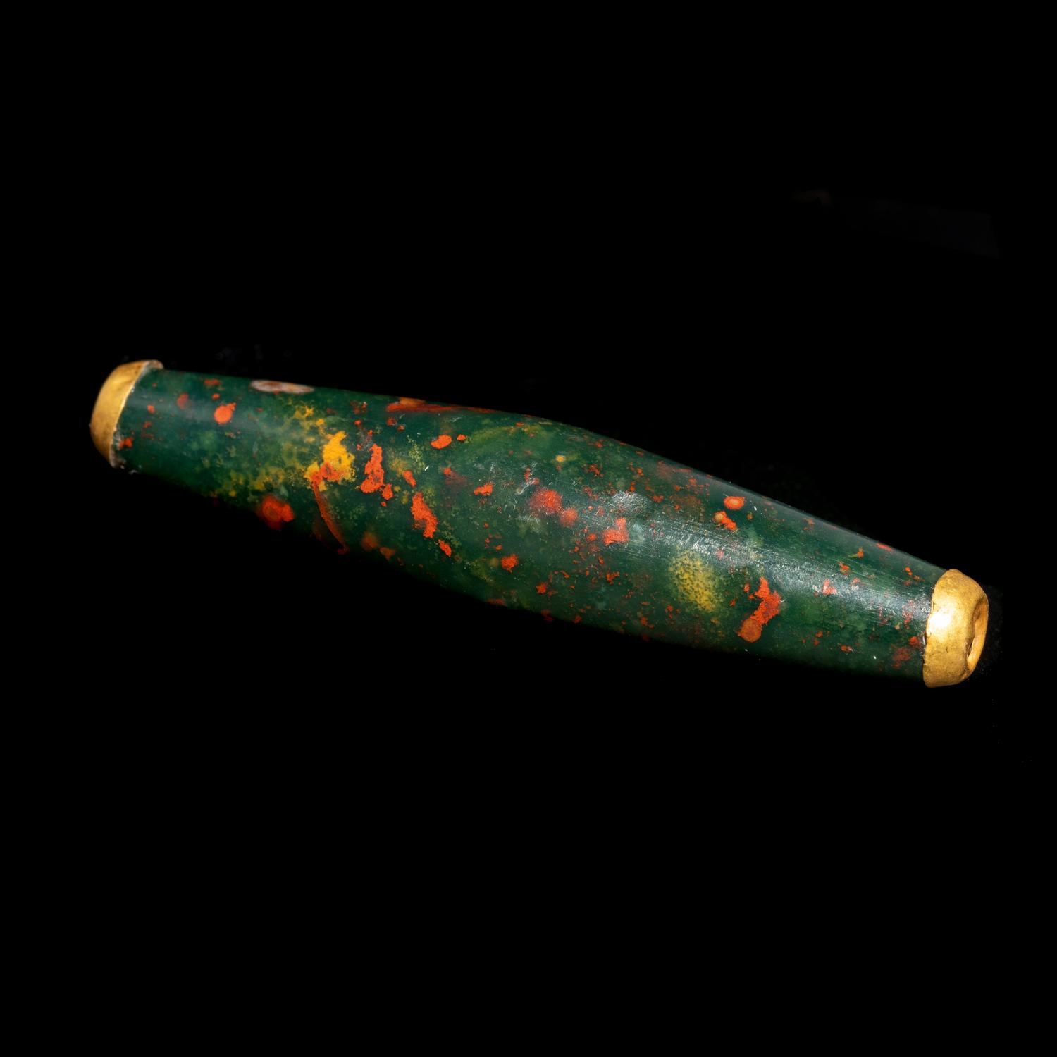 A Near Eastern Bloodstone Bead with Gold Caps