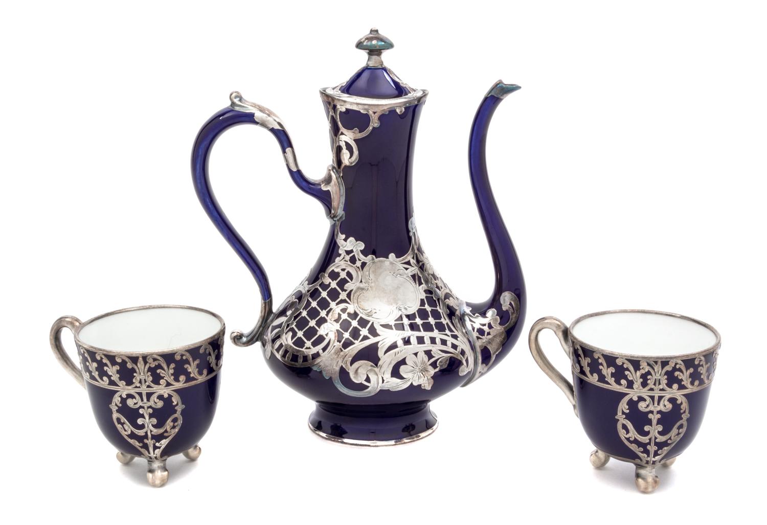 Three Porcelain Silver Overlay Tea Articles Height of first 8 1/4 inches.