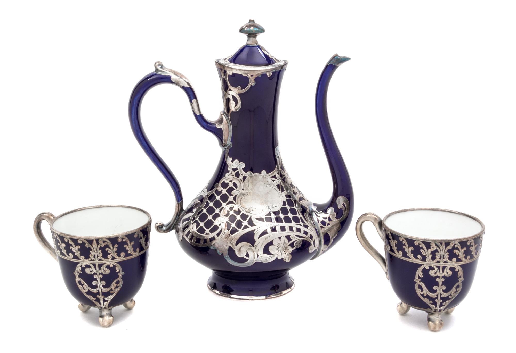 Three Porcelain Silver Overlay Tea Articles Height of first 8 1/4 inches.