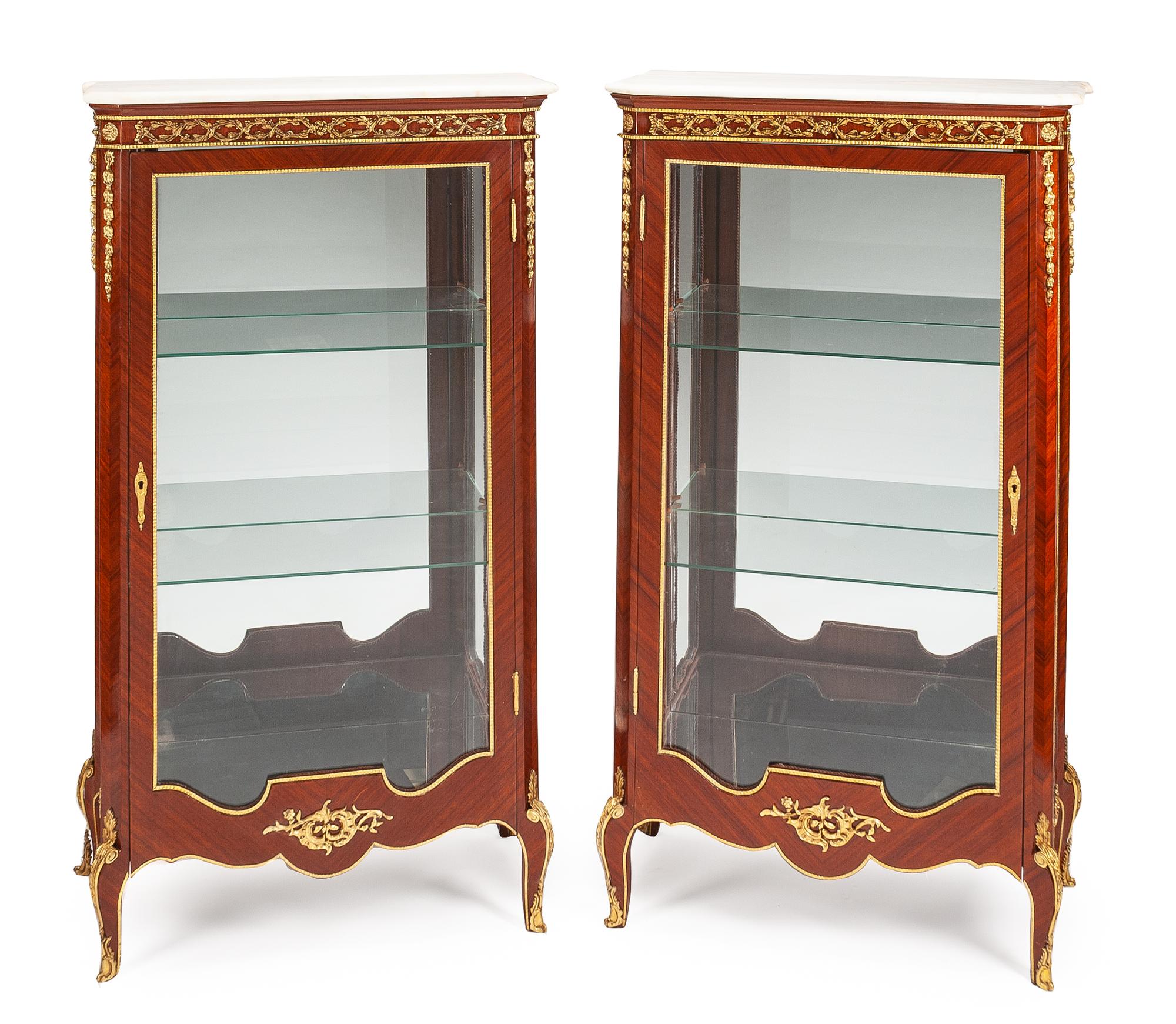A Pair of Louis XV Style Vitrine Cabinets Height 59 3/4 x width 34 x depth 18 inches.