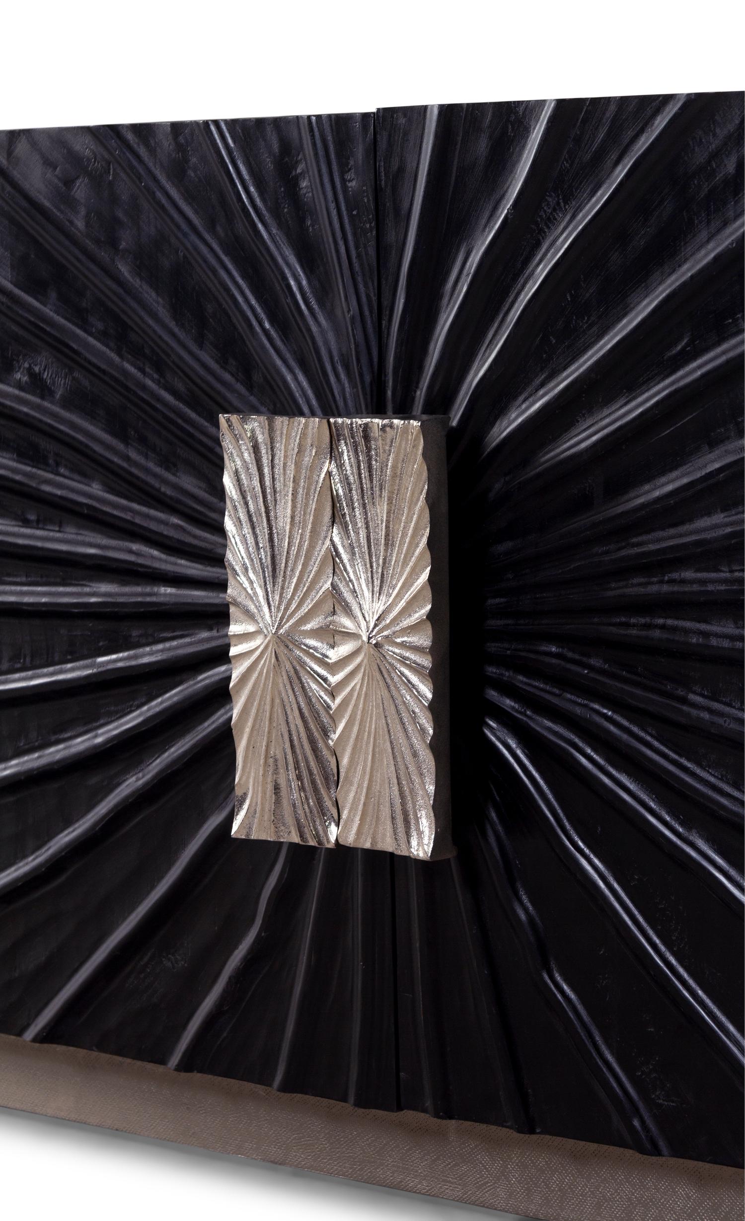 A Contemporary Ebonized Sculpture-Front Cabinet