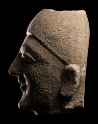 A Cypriot Limestone Head of a Man Wearing a Helmet